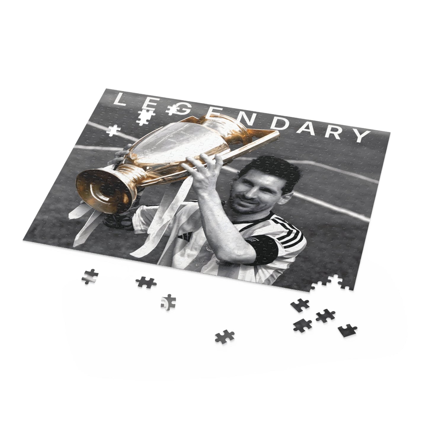 Lionel Messi Soccer Game - Vintage Glory puzzle set featuring iconic black and white image of Messi with championship trophy, available in 120, 252, 500 pieces.