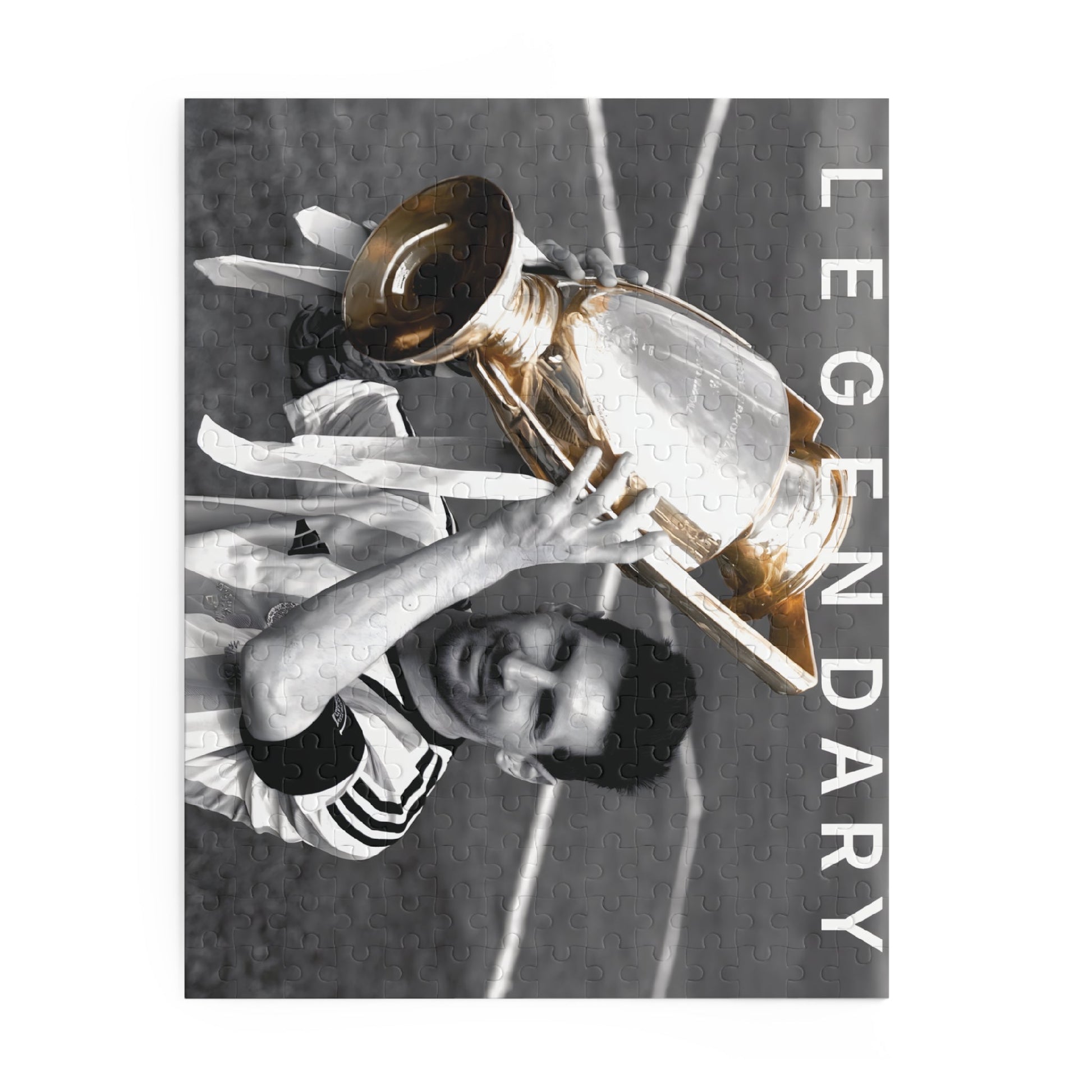 Lionel Messi Soccer Game - Vintage Glory Puzzle Set featuring Messi with a championship trophy in black and white with colored uniform.